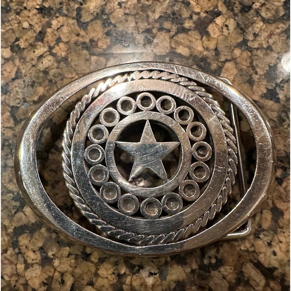 Silver star belt buckle.